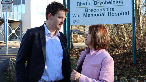 Jane and David speaking outside a hosptial