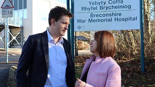 Jane and David speaking outside a hosptial