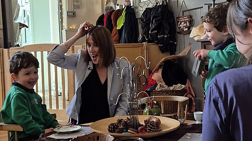 Jane Dodds MS at a nursery visit with children and staff, they are playing with wooden toys
