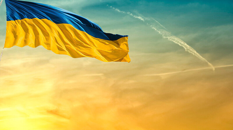 A Ukrainian flag at sunset