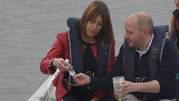 Jane and Sam sampling water