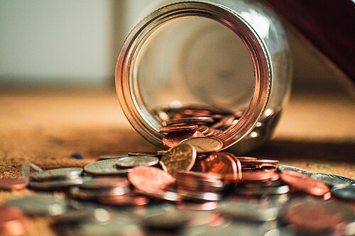 Coins coming out of a jar